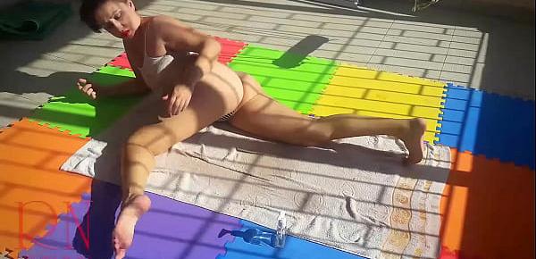  An attractive lady is sunbathing on the roof of her house. Nude yoga TEASER 1